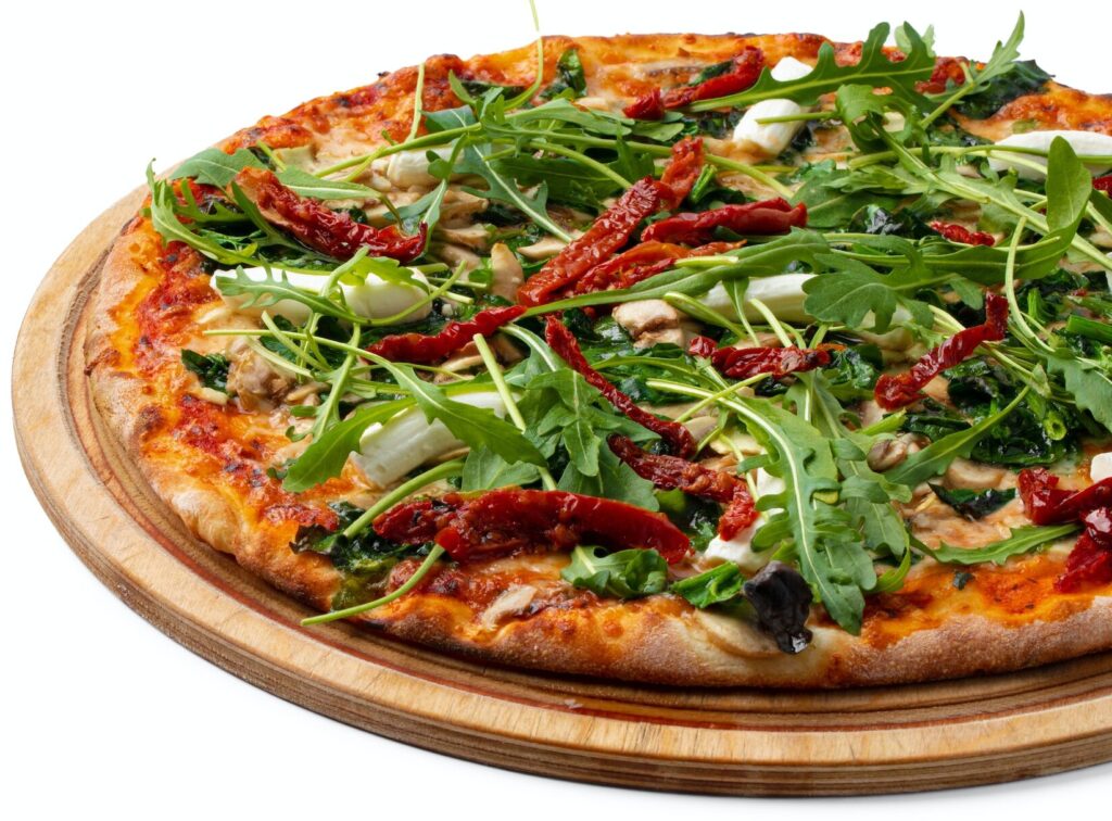 Fresh pizza on wooden board isolated on white